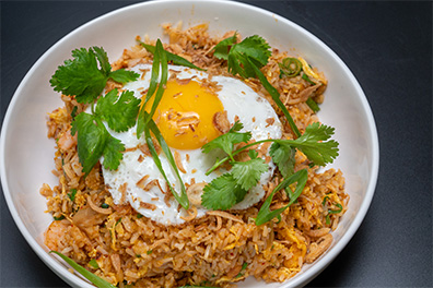 Rice dish with egg on top made for Stratford Asian food delivery.